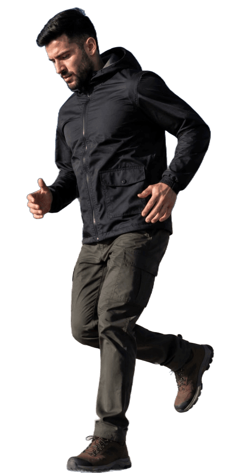 Athlete in a lightweight jacket and cargo trousers running down stadium steps