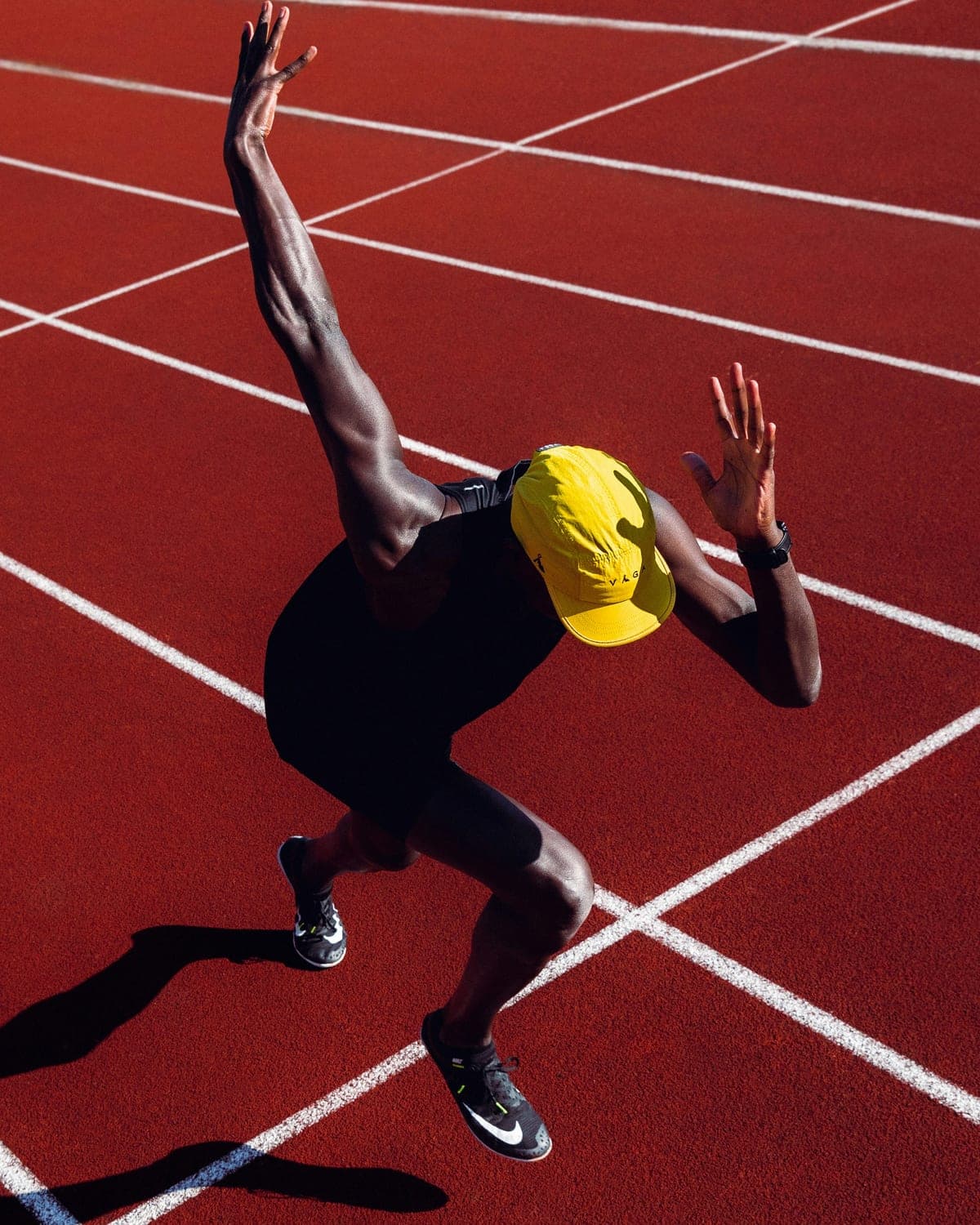 Sprinter starting a run on a red track